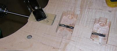 Drilling the hole for the neck tenon dowel and the wiring.