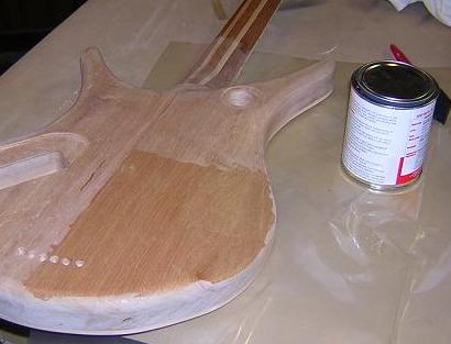 Filling the mahogany grain.