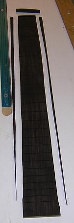 Cutting the fingerboard to length and tapering.