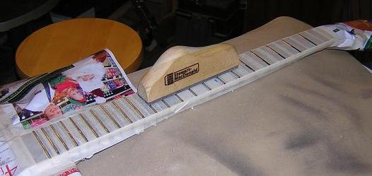 Leveling the frets with a file.