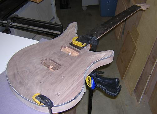 How To Hold A Guitar Neck. Gluing the neck to the body.
