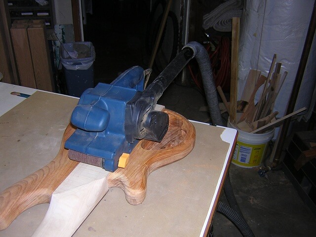 Using the belt sander to level the back.