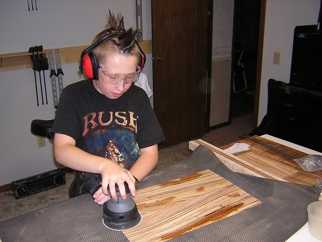 Tundra Boy sanding the glued bookmatched back piece.