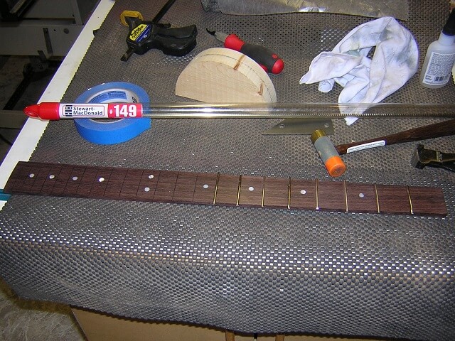 Installing the frets.