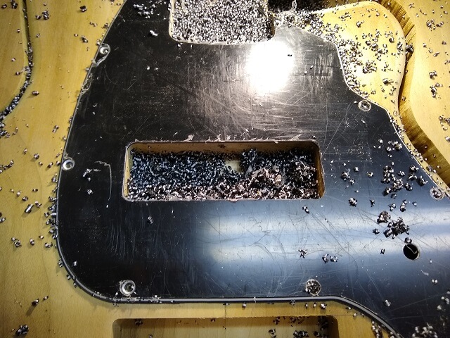 Routing the neck pickup hole in the pickguard.