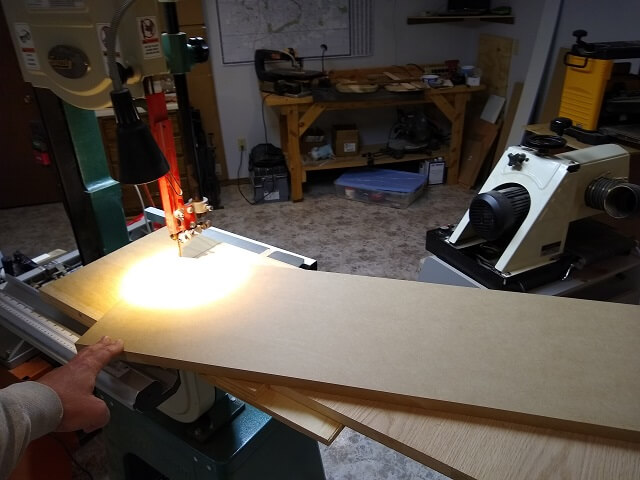 Using the circle cutting jig on the band saw to cut the radius rails.