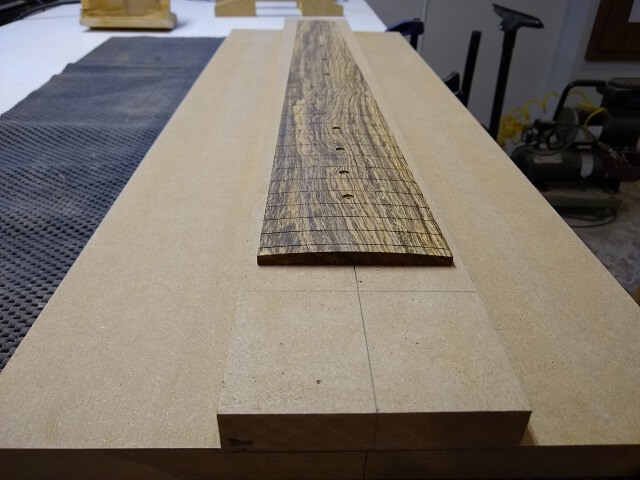 The completed fretboard radius.