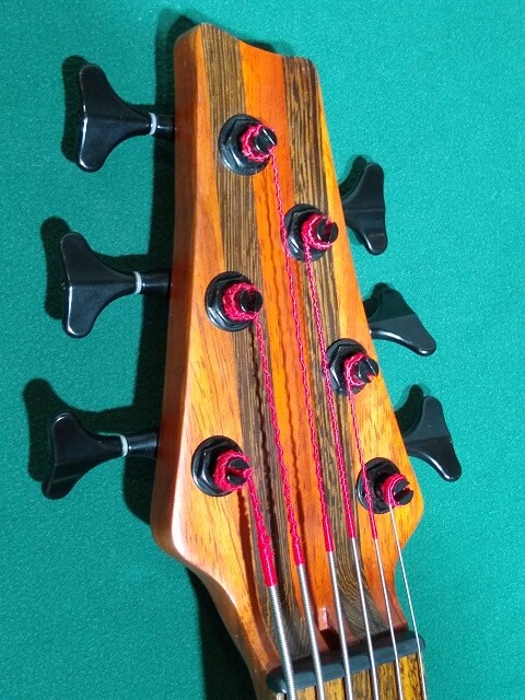 A closeup of the front left side of the headstock.