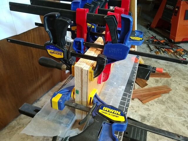 Laminating together plywood to make the drawer slider spacers.