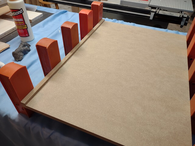 Gluing the lip to the front of the keyboard tray..