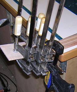 Gluing veneer onto the back of the headstock.