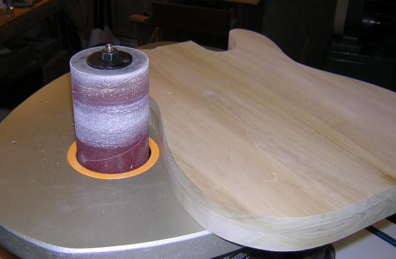 Sanding the body edge to shape.