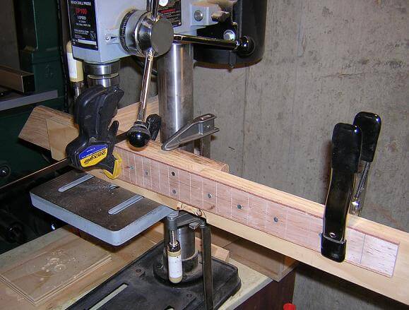 Drilling the fretboard side dot holes.