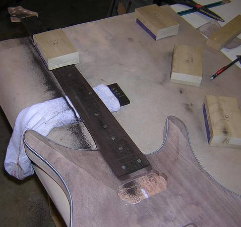 Sanding the radius into the fretboard.