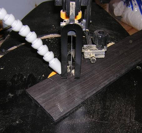 Cutting the decorative fretboard end.