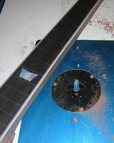 Routing the neck flush with the fretboard.