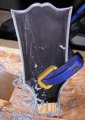 Scraping the headstock binding flush.