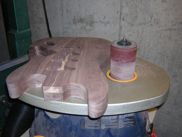 Sanding the body edges smooth.