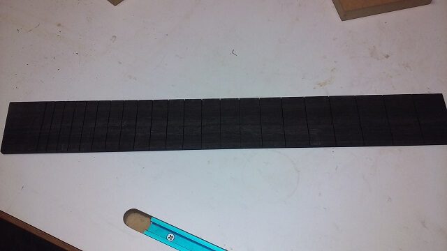 The slotted fretboard.