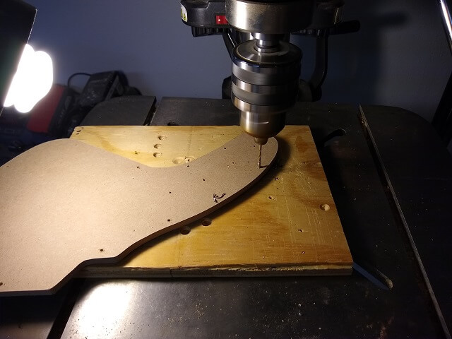 Drilling the screw holes in the pickguard.