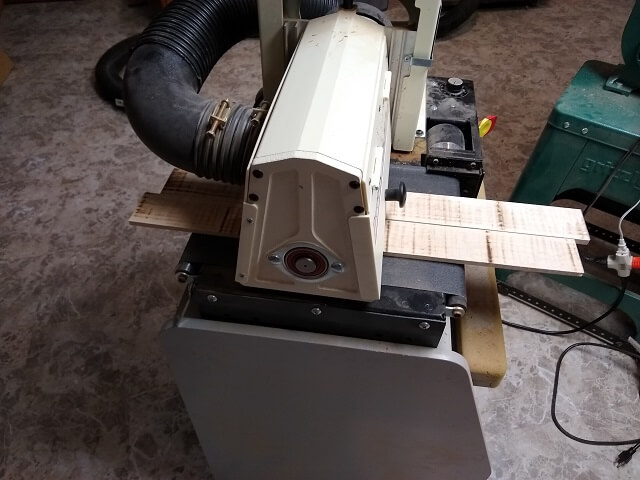 Sanding the face of the fretboards smooth.