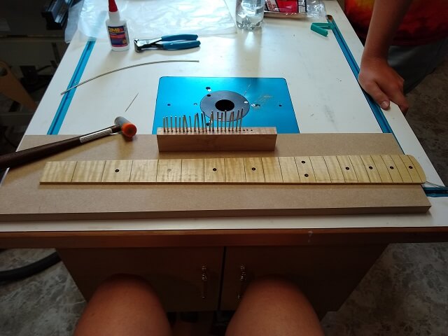 Installing the frets.