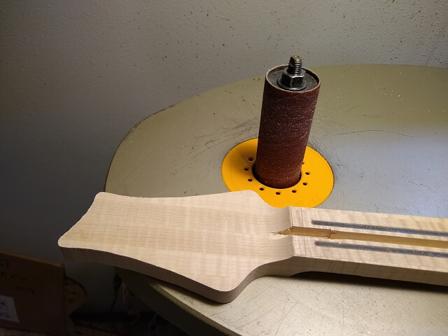 Sanding the headstock to final shape.