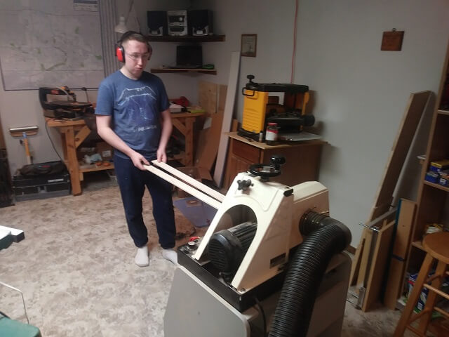 Sanding the rough sides of the neck lamination pieces.