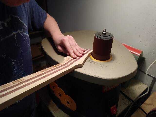 Sanding the headstock to final shape.