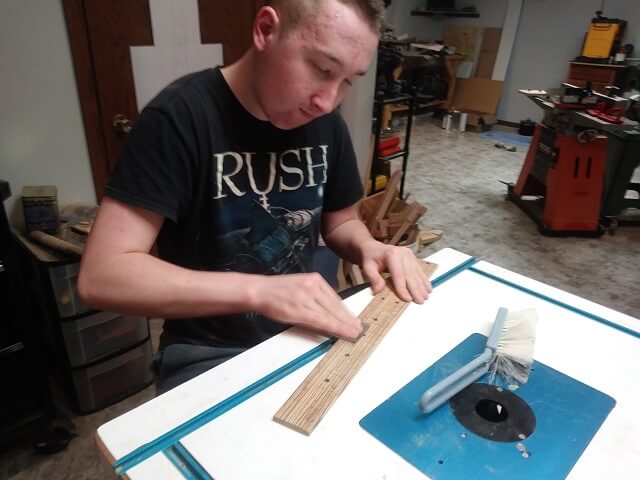 Fine sanding the fretboard face.