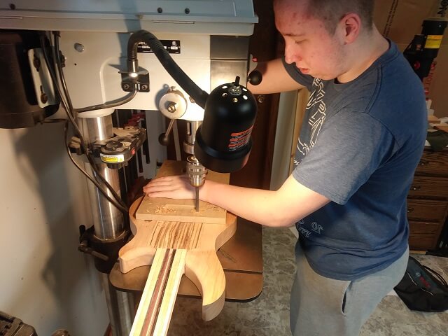 Drilling the holes for the tremolo studs.