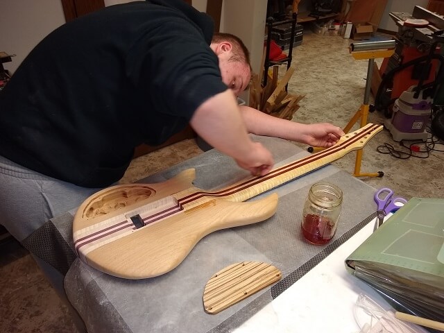 Applying shellac to the guitar.