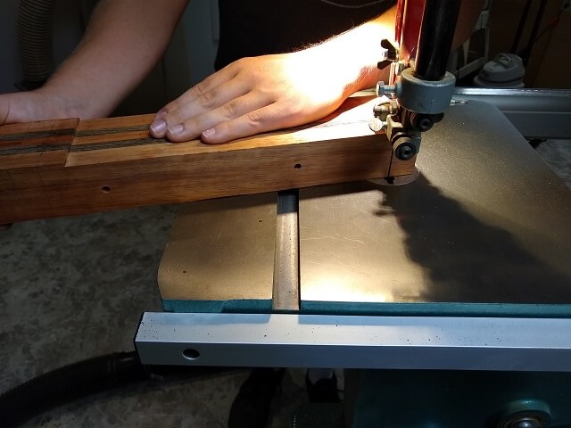 Cutting the body end of the neck blank to shape.