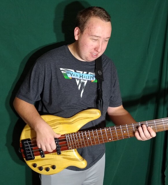 A closeup of the Tundra Boy playing his instrument.