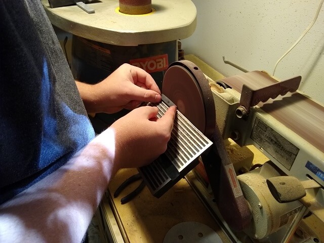 Sanding the nut to rough shape.