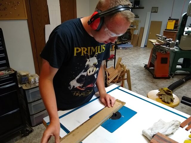 Flush cutting the taper on one side of the fretboard.