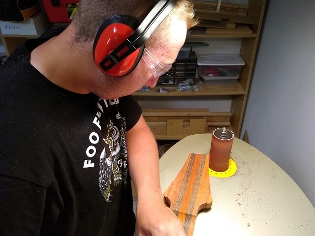 Sanding the headstock to final shape.