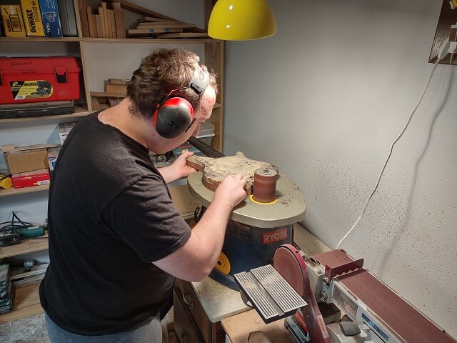 Sanding the end of the ebony neck flush with the top.