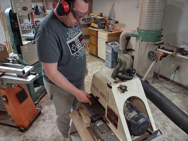 Sanding the tremolo cavity cover to thickness.