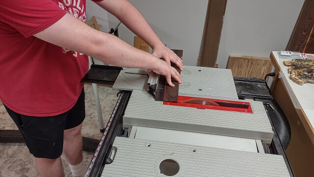 Trimming the body end of the fretboard.