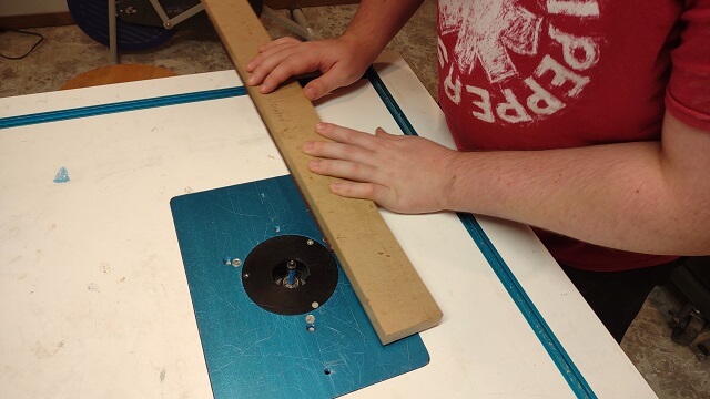 Trimming the sides of the fretboard to final size.