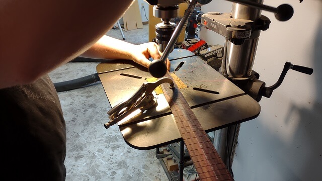 Drilling the fret dot marker holes.