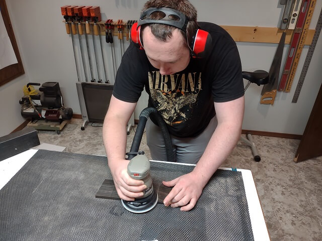 Sanding the face of the headstock smooth with the ROS.