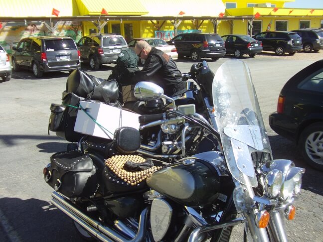 Strapping our boxes of goodies to the back of the bikes.