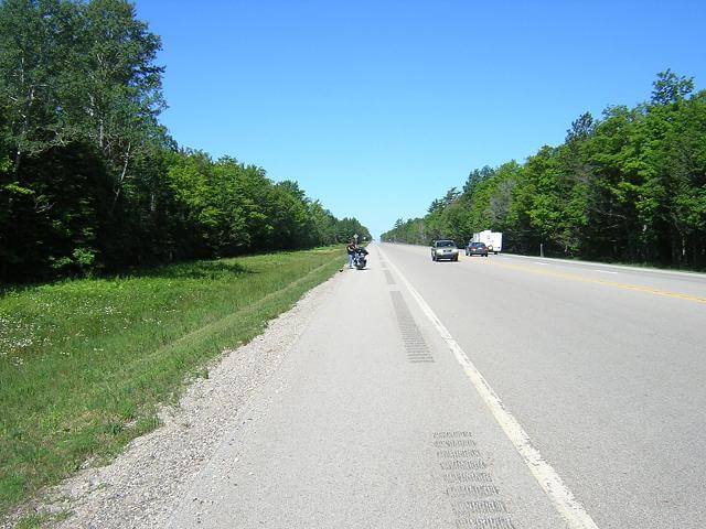 Helping a fellow biker.