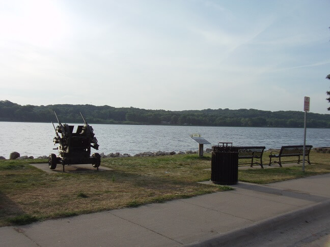 A war memorial next to the river.