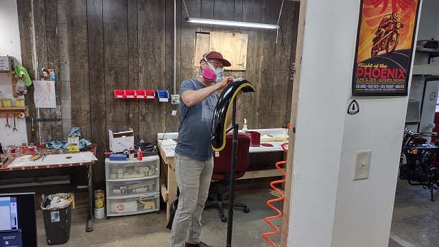 A Janus employee painting a fender.