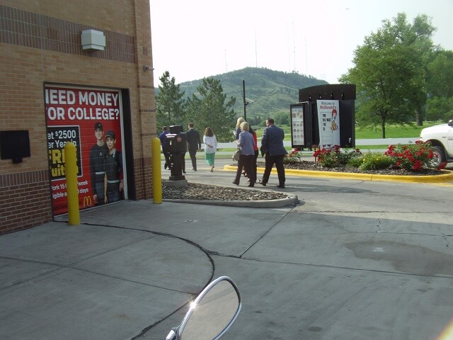 The suits touring the outside of the building.