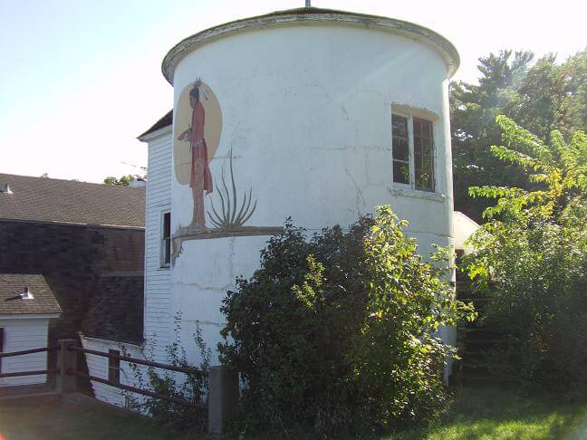 The prayer room being overgrown with weeds.