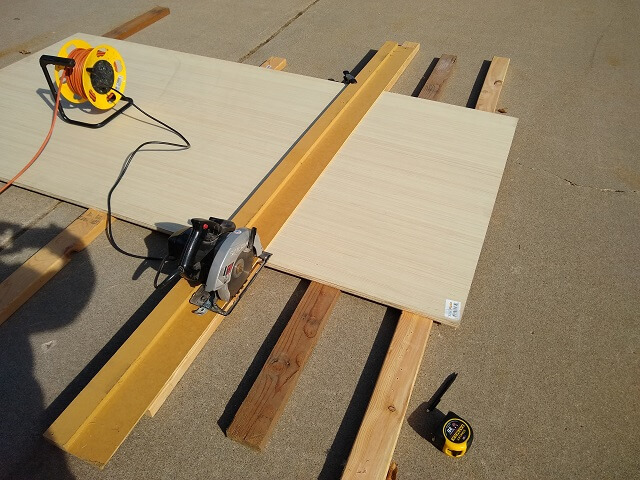 Using a sawboard to trim the cabinet side height.